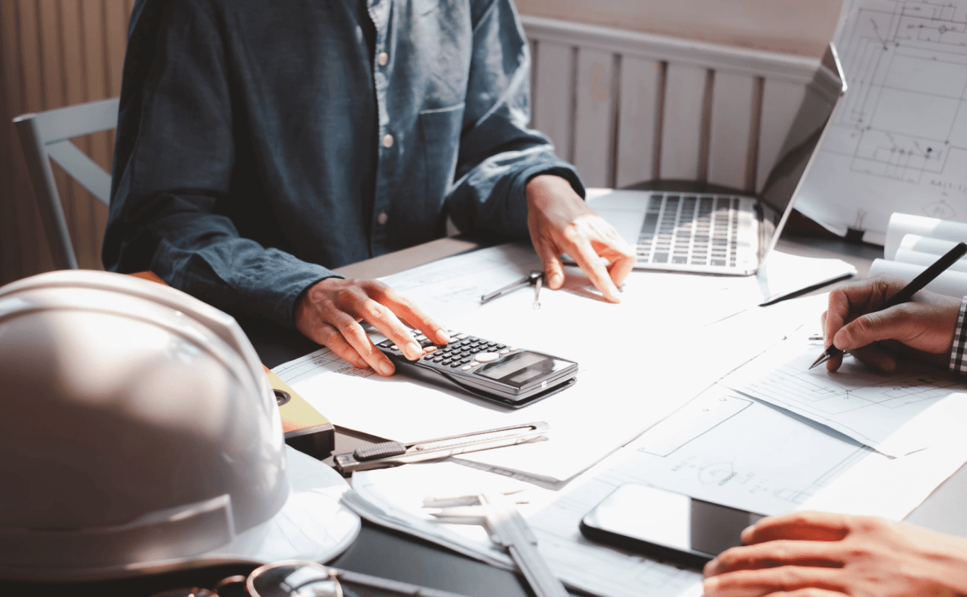 Construction project planning meeting with safety equipment